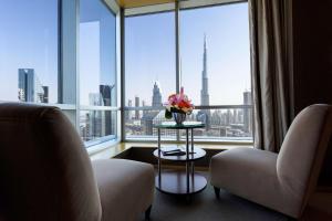 a living room filled with furniture and a window at Shangri-La Dubai in Dubai