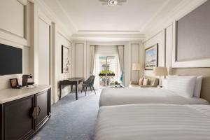 a hotel room with two beds and a desk at Shangri-La Bosphorus, Istanbul in Istanbul