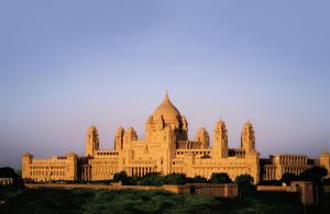 a large building in front of a sunset at Umaid Bhawan Palace Jodhpur in Jodhpur