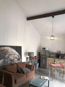 a living room with a couch and a table at Matin de Saône in Fontaines-Saint-Martin