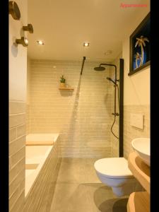 a bathroom with a shower and a toilet and a sink at Onder de Molen in Garderen