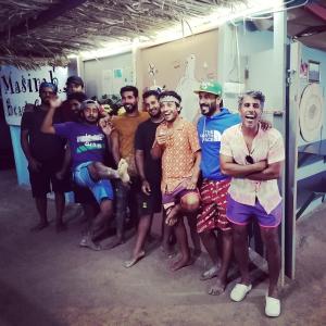 a group of men posing for a picture in a room at Masirah Beach camp in Al Qārin