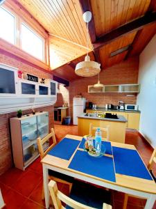 a kitchen with a table and chairs in a room at Cozy Beach House in Ribeira Grande