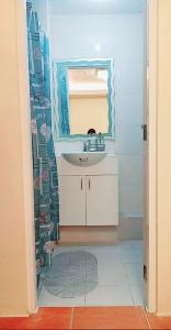 a bathroom with a sink and a mirror at One Oasis By Paseo de Corazon Residence in Cagayan de Oro