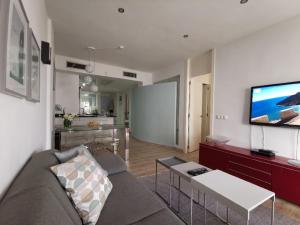 A television and/or entertainment centre at Otylia La Calma Sun Apartment With Sea View