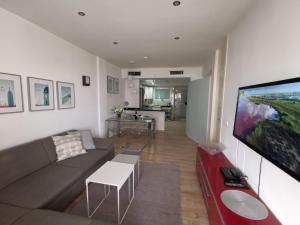 A television and/or entertainment centre at Otylia La Calma Sun Apartment With Sea View