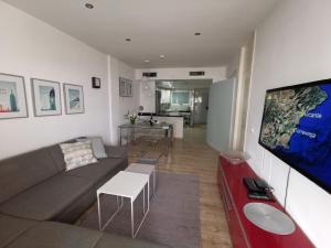 A television and/or entertainment centre at Otylia La Calma Sun Apartment With Sea View