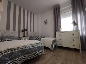 A bed or beds in a room at Otylia La Calma Sun Apartment With Sea View