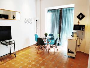 セビリアにあるStyle Apartment El Patio Trianaのリビングルーム(テーブル、椅子付)
