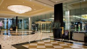 a lobby with a chandelier and a checkered floor at Westgate Las Vegas Resort and Casino in Las Vegas