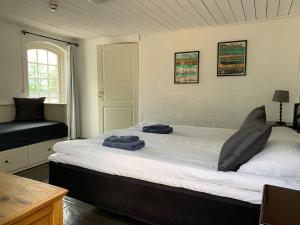 a bedroom with a large bed with two towels on it at Husargårdens Bed & Breakfast in Sjöbo