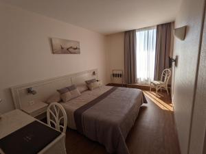 a hotel room with a bed and a window at Hotel Mira-Mar in Valras-Plage