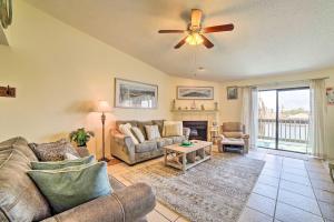 a living room with a couch and a ceiling fan at Waterfront Luxury House: Dock, Fire Pit & Fishing in Corpus Christi