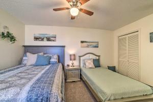 a bedroom with two beds and a ceiling fan at Waterfront Luxury House: Dock, Fire Pit & Fishing in Corpus Christi +22 photos