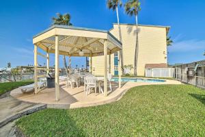a gazebo with chairs and a table at Waterfront Luxury House: Dock, Fire Pit & Fishing in Corpus Christi