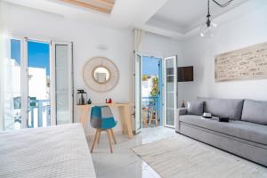ミコノス・シティにあるCentral Suites Mykonosのリビングルーム(ソファ、テーブル付)