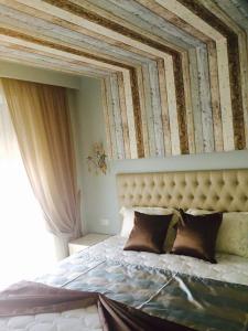 a bedroom with a large bed with a large window at Colibri Luxury Apartments in Hanioti