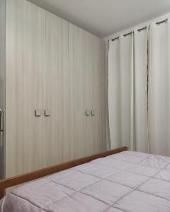 a bedroom with a bed and some closets at Kiterhouse in Case Milazzo