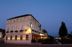 a white building with a clock on the side of it at Gasthof Klinglhuber in Krems an der Donau