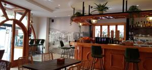 a bar in a restaurant with a table and chairs at Hotel Teremar in Benidorm