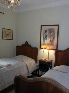 1 dormitorio con 2 camas y una lámpara en una mesa en Villa Eden, en Menton