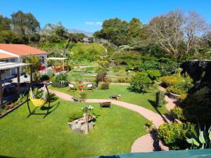 un patio trasero con jardín y parque en Quinta dos Sentidos Eco Nature Retreat in Azores, en São Vicente Ferreira