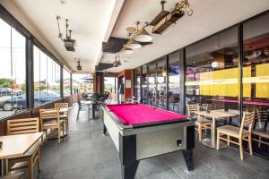 a pool table in a restaurant with tables and chairs at Nightcap at Millers Inn in Altona