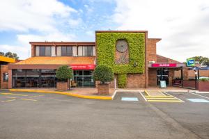 a building with ivy growing on the side of it at Nightcap at Millers Inn in Altona