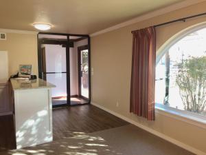 an empty living room with a large window at Downtown Motel Woodward in Woodward