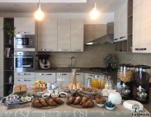 a kitchen with a bunch of food on a table at La Quercia in Pachino