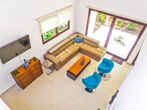 an overhead view of a living room with a couch and chairs at Luxury Tao Ocean Akumal in Akumal
