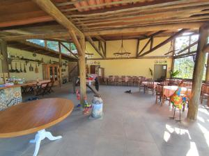 a large room with tables and chairs in a building at Pousada Recanto da Lunane in Barra do Piraí