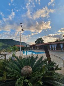 a view of a resort with a pineapple at Pousada Recanto da Lunane in Barra do Piraí