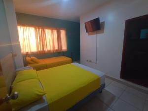 Postel nebo postele na pokoji v ubytování Hostal El Naufrago 1