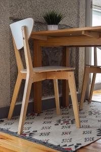 a wooden desk with a chair next to a table at Aurora Garden in Porto