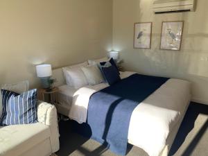 a bedroom with two beds and a couch at Lorne Studio Apartment in Lorne