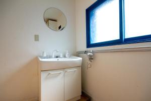 a bathroom with a sink and a mirror at kODATEL Hakodate Ocean in Hakodate +12 photos