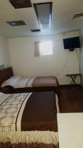 Giường trong phòng chung tại Hotel Centric Chihuahua