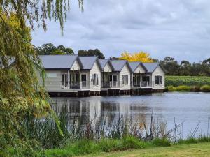 a row of houses on a dock on a river at Crittenden Lakeside Villas in Dromana