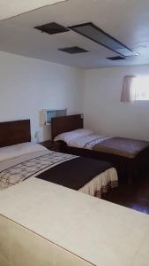 Un pat sau paturi într-o cameră la Hotel Centric Chihuahua