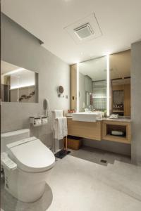 a bathroom with a toilet and a sink at Taipei Garden Hotel - Ximending in Taipei