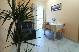 a dining room with a table and a plant at La Familia Apartments in Makarska