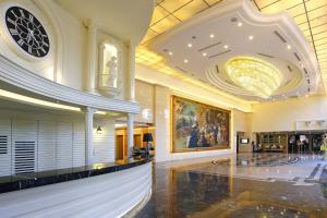 a lobby of a building with a chandelier at Golden Tulip - Aesthetics in Zhunan +85 photos
