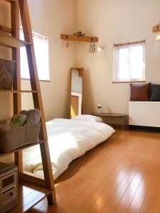 a bedroom with a bed and a large mirror at 毎日が休日 guest house in Aizuwakamatsu
