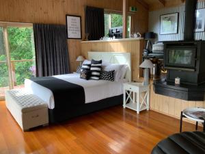 a bedroom with a large bed and a television at Belle's at Montville in Montville
