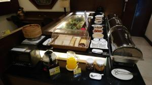 a buffet line with food and drinks in a hotel room at Ta Lee Hotel in Tainan