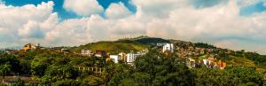 a city on top of a hill with buildings at ApartaEstudios San Cayetano Cali in Cali