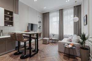 a kitchen and living room with a table and a couch at NEW! Luxury apartment in the CENTER of ODESSA overlooking Deribasovskaya str. LOW PRICE! in Odesa