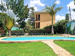 a swimming pool in front of a house at Africa Safari Arusha in Arusha