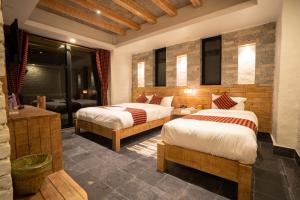 um quarto de hotel com duas camas e um banheiro em Hotel Mera Peak Private Limited em Pokhara